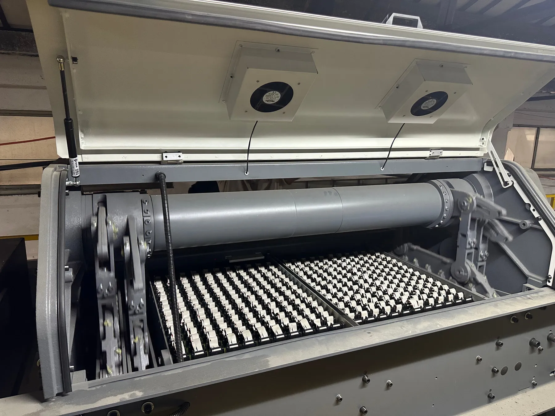 The top of a jacquard machine with its cover open